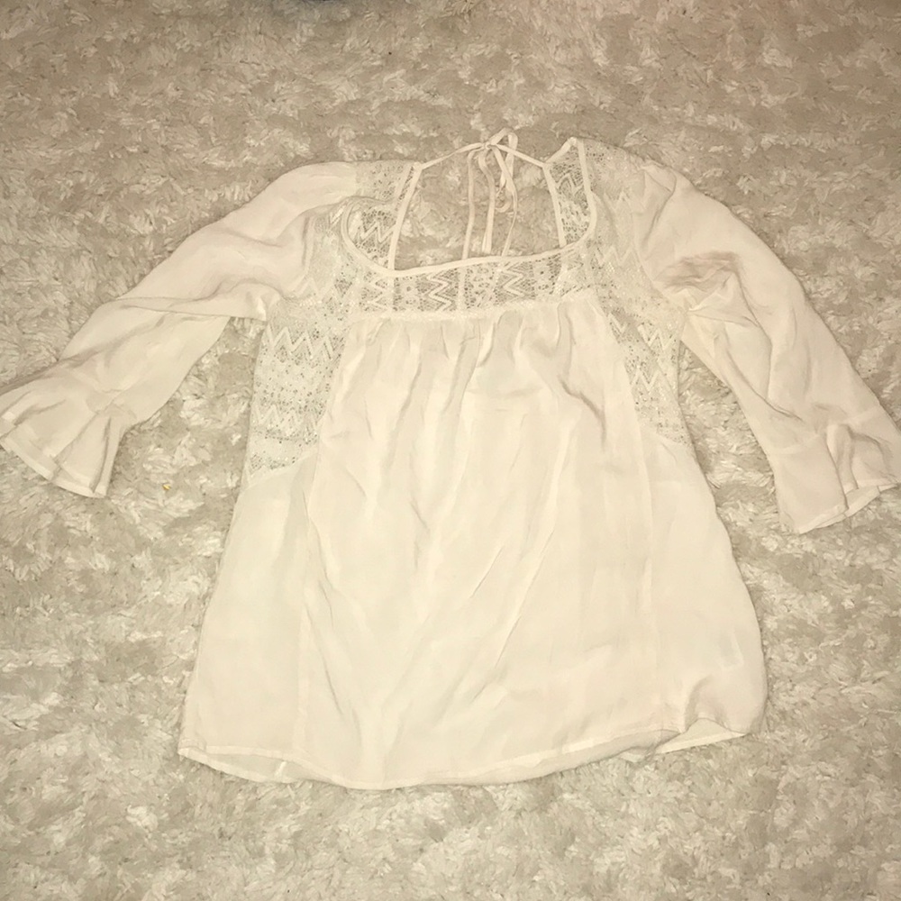 Cream colored blouse with lace and ties in back